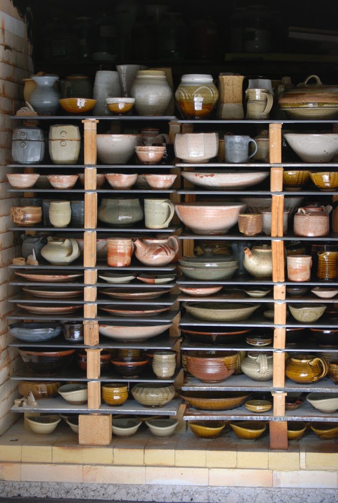 Production pottery studio showing multiple kiln loads with ADVANCER® silicon carbide shelves maximizing firing capacity and efficiency